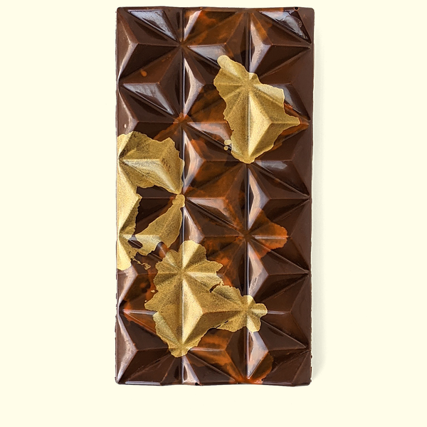 A gourmet chocolate bar hand-painted with cocoa butter in gold and brown. Handmade chocolate bar by online chocolate store Topogato.