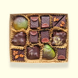 A gourmet chocolate box shown from the top down with assorted handmade chocolate treats from San Francisco chocolate store Topogato.